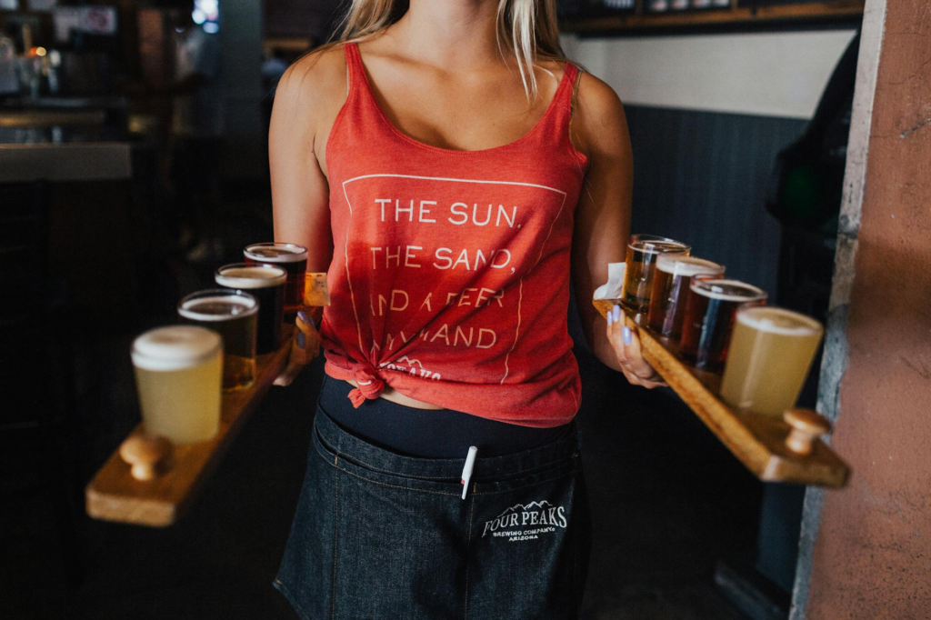 A bartender serving drinks that pair well with cheeseburger sliders Las Vegas Strip.