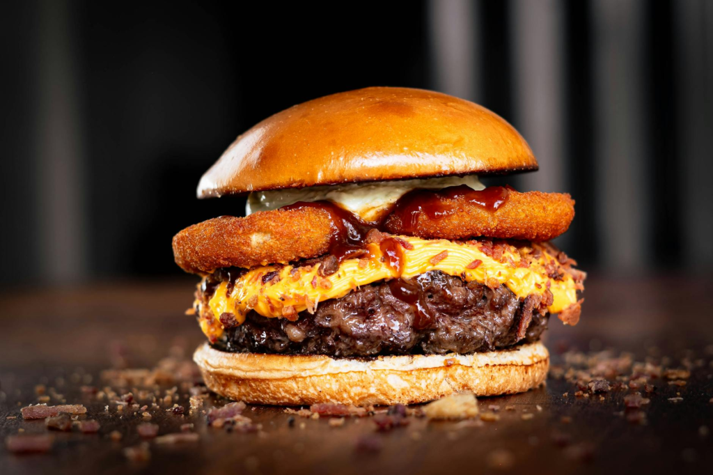 A beautifully arranged spicy burger from Holsteins, featuring bold flavors that are among the top burger specials Las Vegas has to offer.