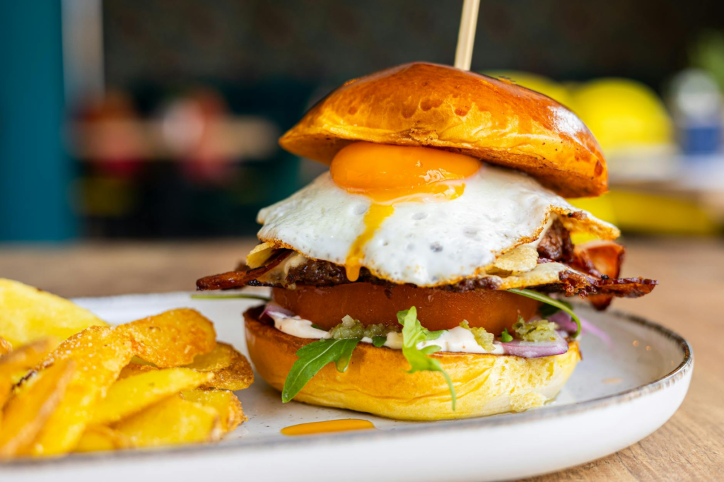 A beautifully plated gourmet burger with fresh ingredients and fries on the side. — gourmet burgers Las Vegas