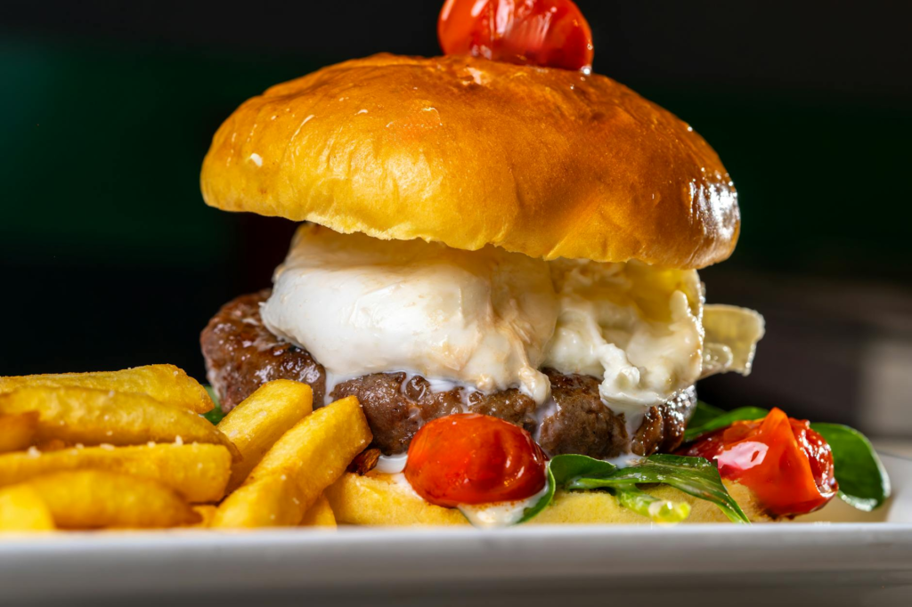 A beautifully plated gourmet burger with unique toppings, garnished and ready to serve. — Las Vegas burger recipes