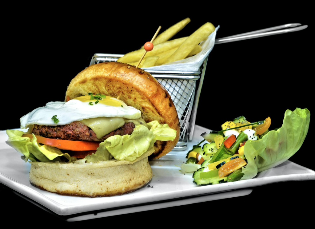 A beautifully plated holiday burger with festive sides like sweet potato fries and a seasonal salad. — Holiday Burger Pa…