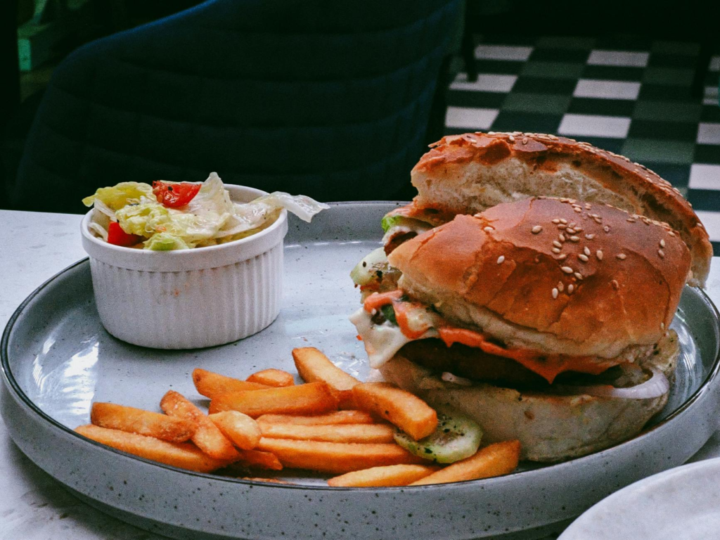 A beautifully plated vegan burger with fresh vegetables and a side of fries. — vegan burgers Las Vegas