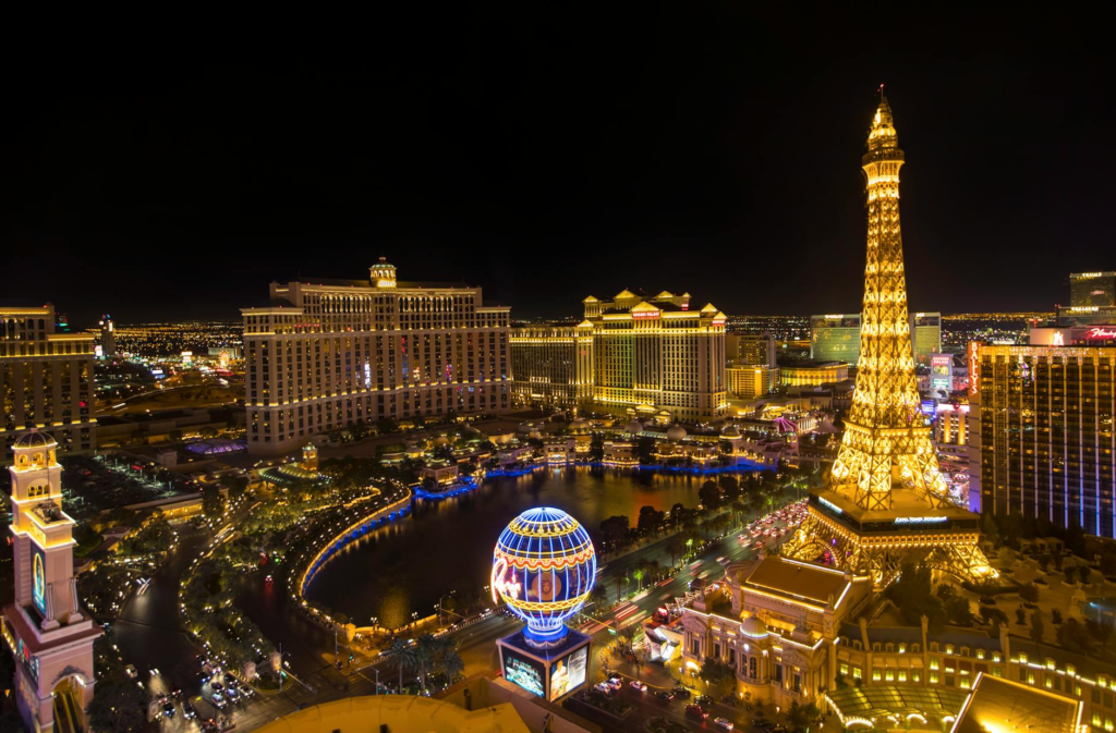 A burger being held up against a backdrop of Las Vegas lights, highlighting the excitement of the city. — Instagrammable…