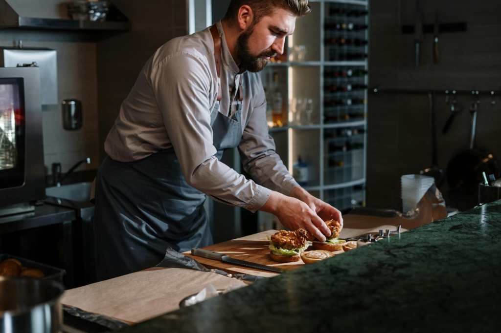 A chef preparing a gourmet burger in the kitchen, highlighting the craftsmanship involved. — gourmet burgers Las Vegas