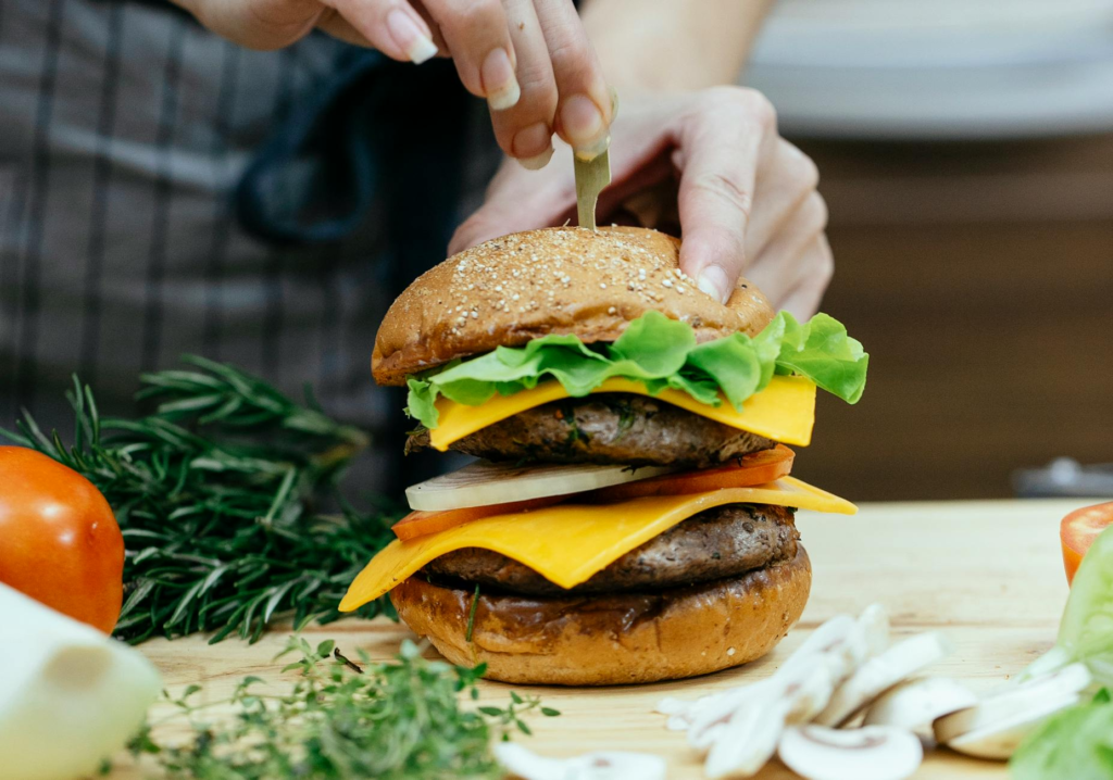 A chef preparing a holiday burger with fresh, local produce. — Sustainable Holiday Burgers Las Vegas