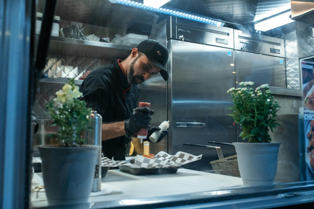 A chef preparing cheeseburger sliders in a food truck kitchen — cheeseburger slider food trucks Las Vegas