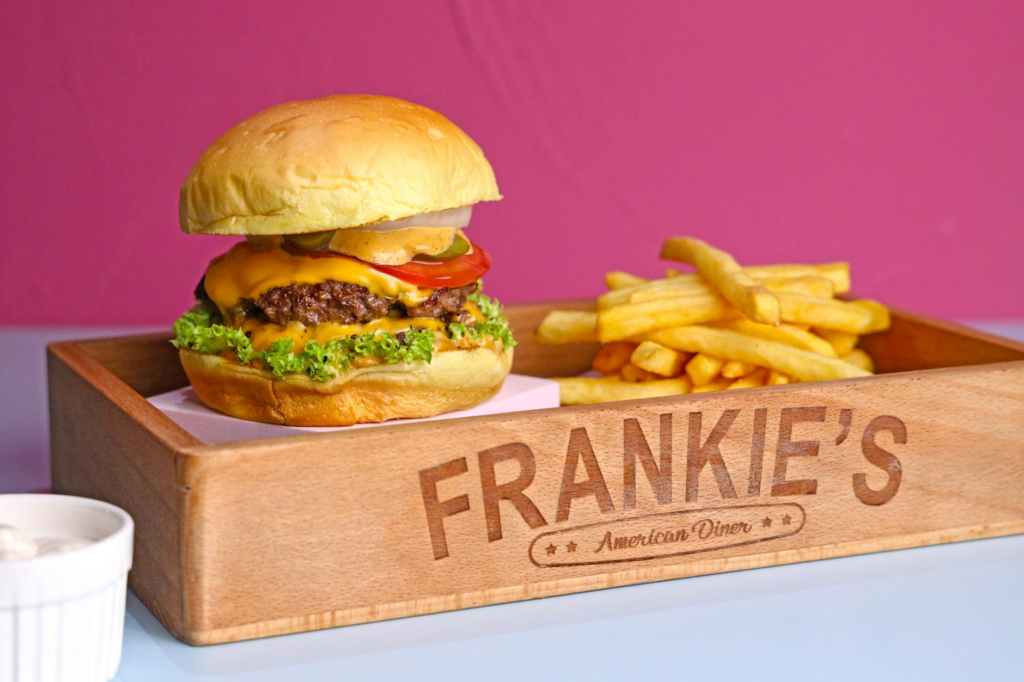A classic American burger served with fries at a Las Vegas diner. — History of Burgers Las Vegas