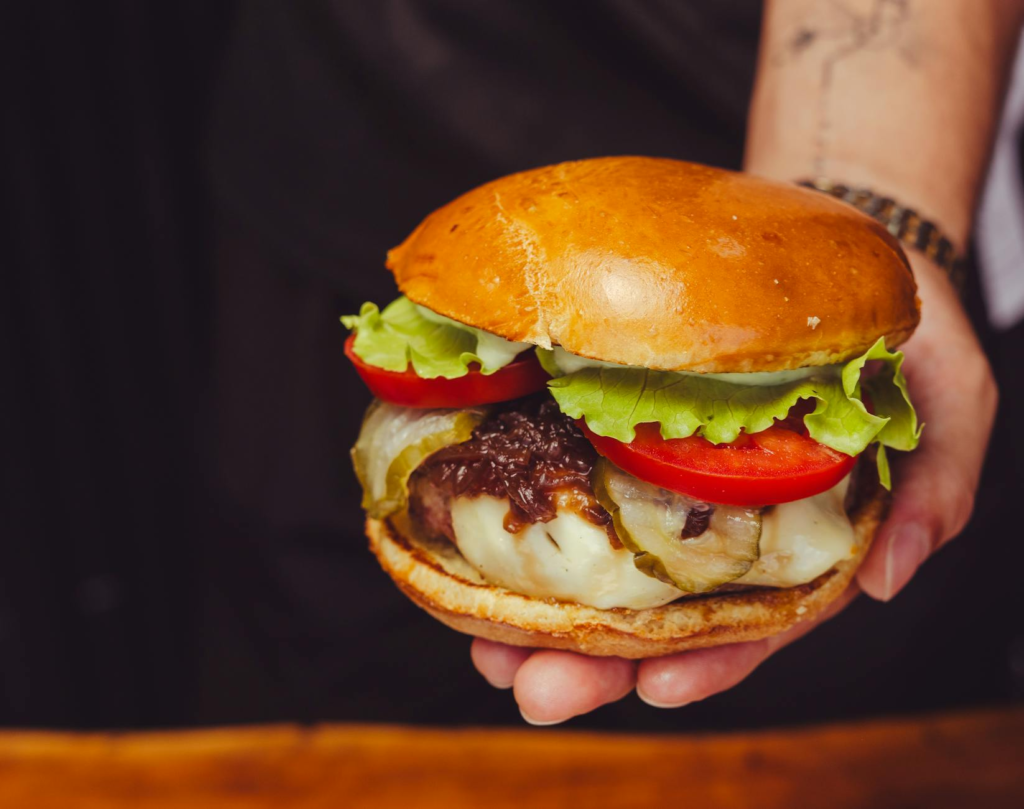 A close-up of a gourmet burger with fresh ingredients at a hidden gem. — hidden burger gems Las Vegas