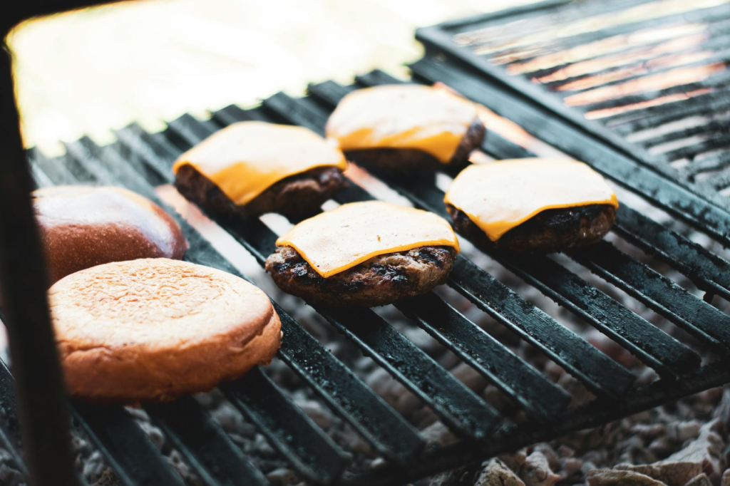 A close-up of a juicy cheeseburger being grilled to perfection. — classic cheeseburgers Las Vegas