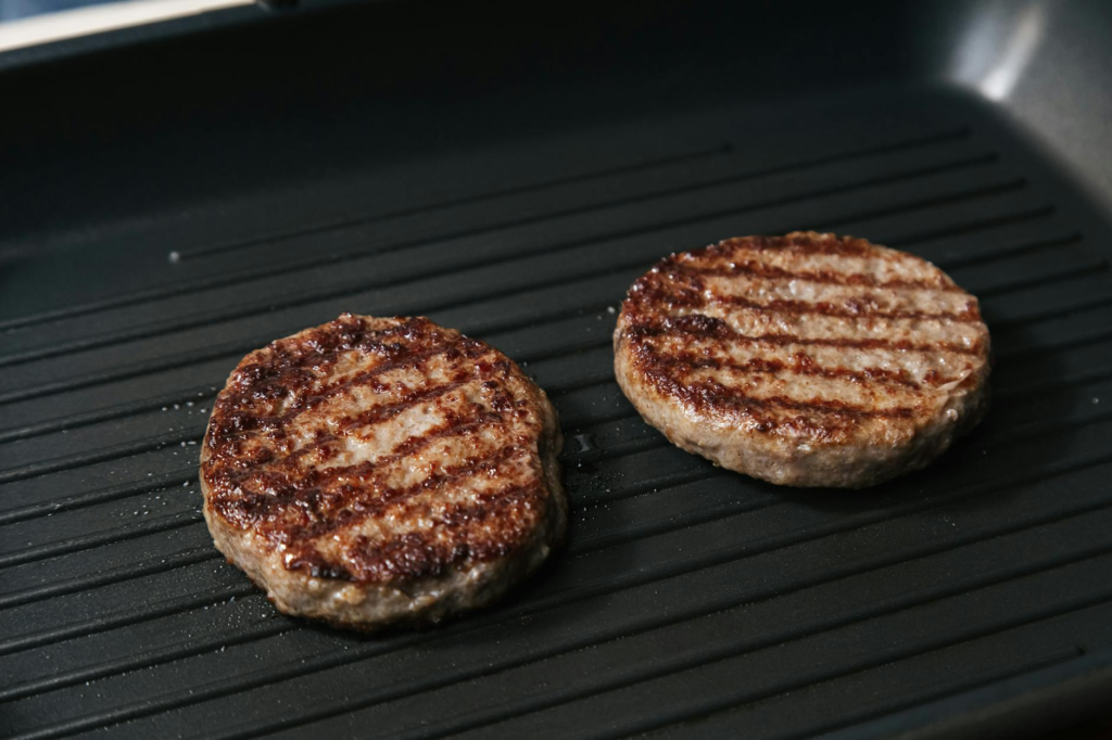 A close-up of a plant-based burger patty being grilled — vegan burgers Las Vegas