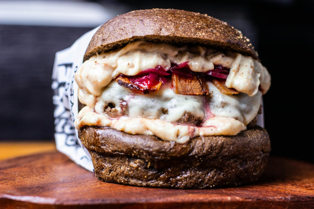 A close-up shot of a signature vegan burger, highlighting unique toppings and sauces — vegan burgers Las Vegas