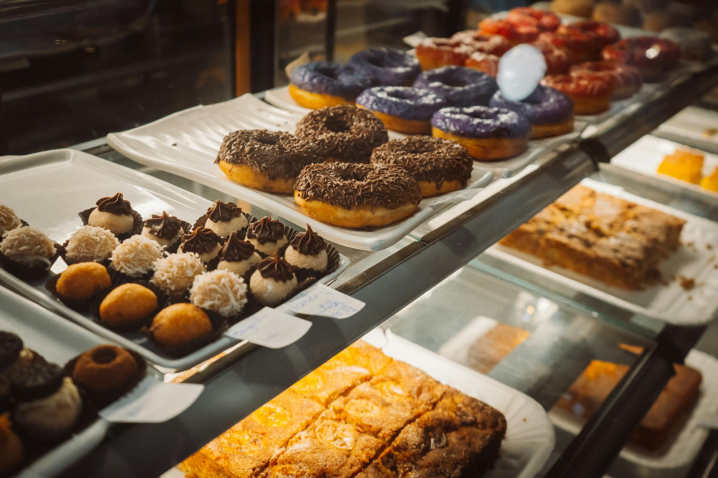 A colorful display of assorted desserts that pair well with burgers, including milkshakes and holiday-themed pastries. —…