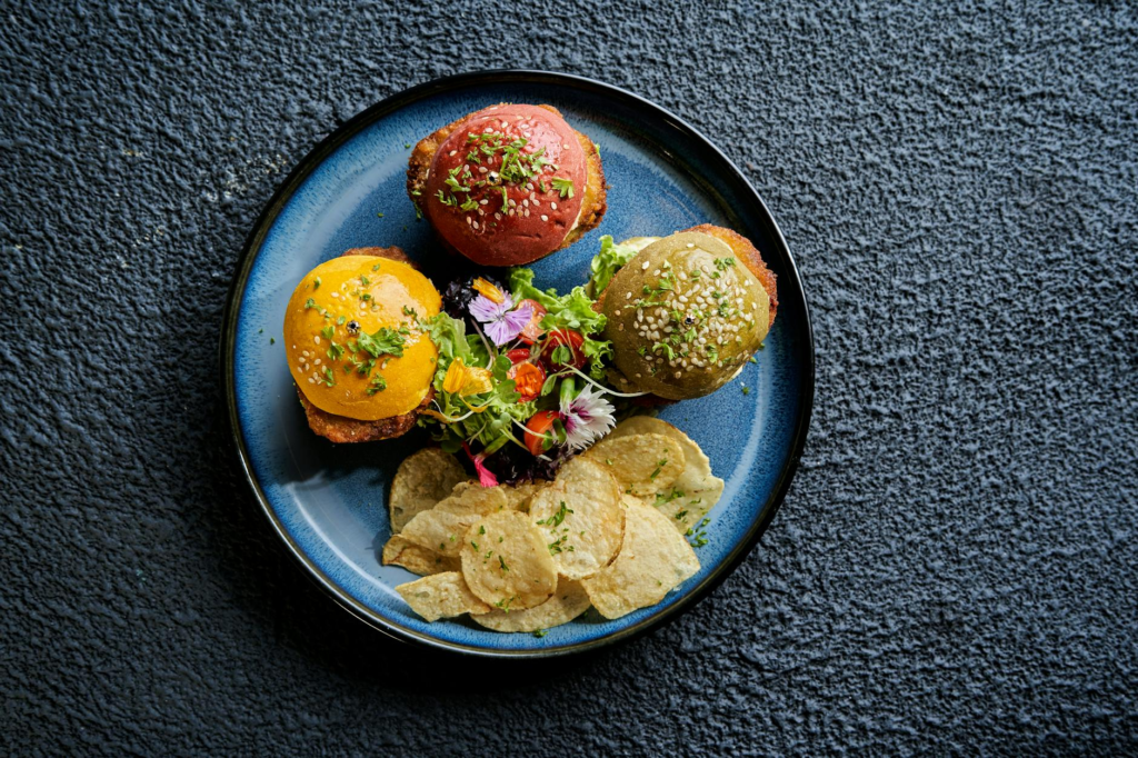 A colorful plate of gourmet vegan burgers with various toppings at a Las Vegas restaurant. — vegan burgers Las Vegas