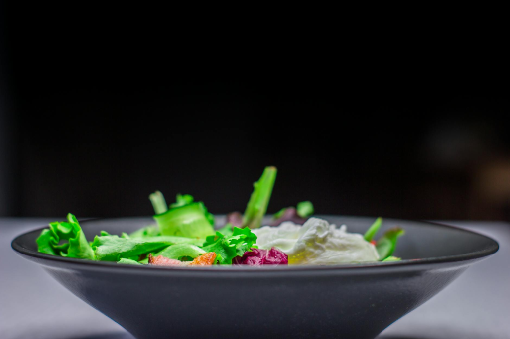 A colorful salad bowl that complements cheeseburger sliders, featuring fresh greens and vegetables. — side dishes for ch…