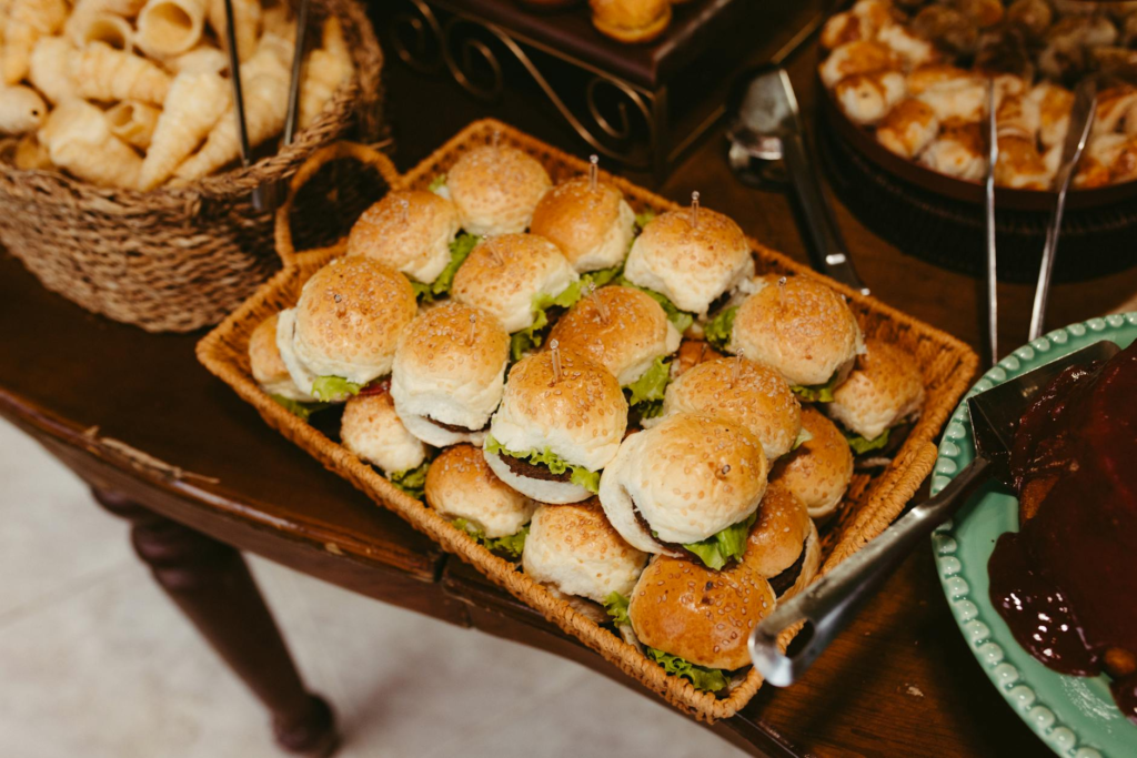 A colorful spread of DIY cheeseburger slider kits on a party table.