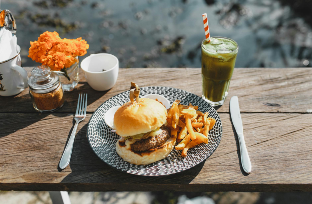 A colorful vegan burger with fresh greens and a refreshing juice. — burger combos Las Vegas