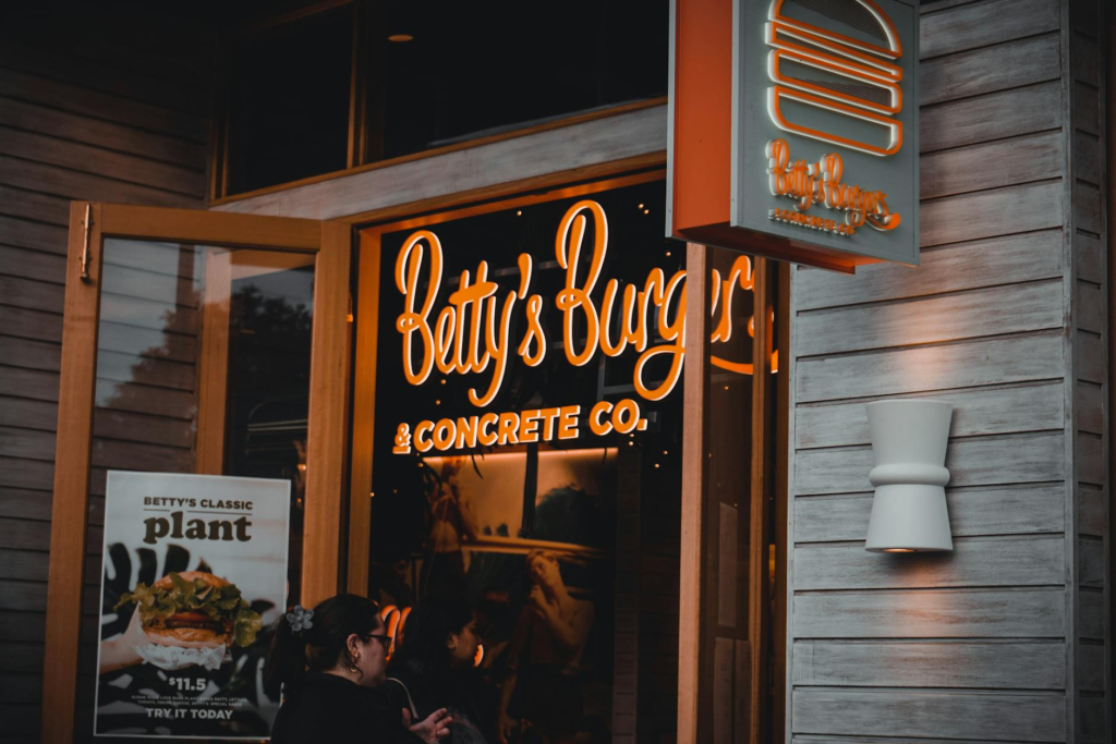 A cozy burger joint atmosphere with patrons enjoying their meals during the nightlife. — late night burgers Las Vegas