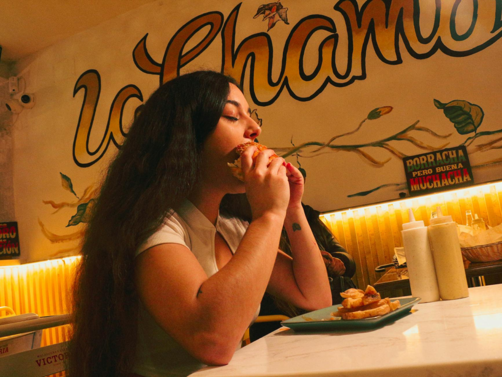 A cozy interior shot of a local burger spot filled with happy diners enjoying their meals. — best burger joints Las Vegas
