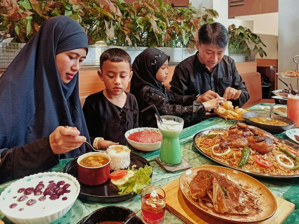 A family enjoying a meal at a restaurant known for children's burgers — Kid-Friendly Holiday Burgers Las Vegas