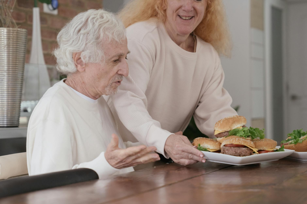 A family enjoying cheeseburger sliders together at a dining table. — cheeseburger slider meal prep