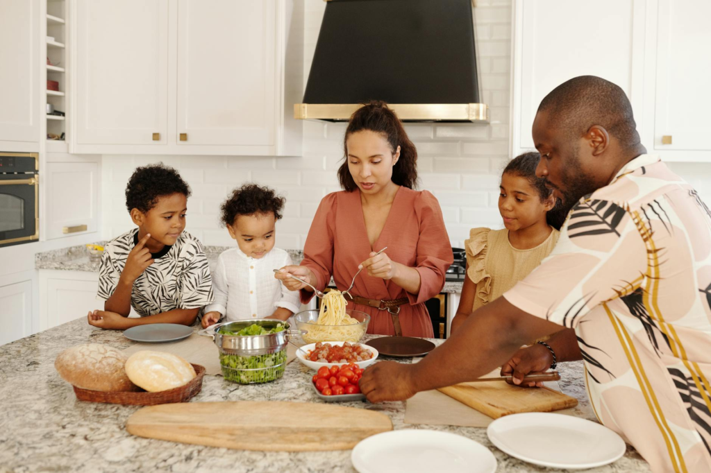 A family gathered around the kitchen making burgers together. — Create Holiday Celebration Burger