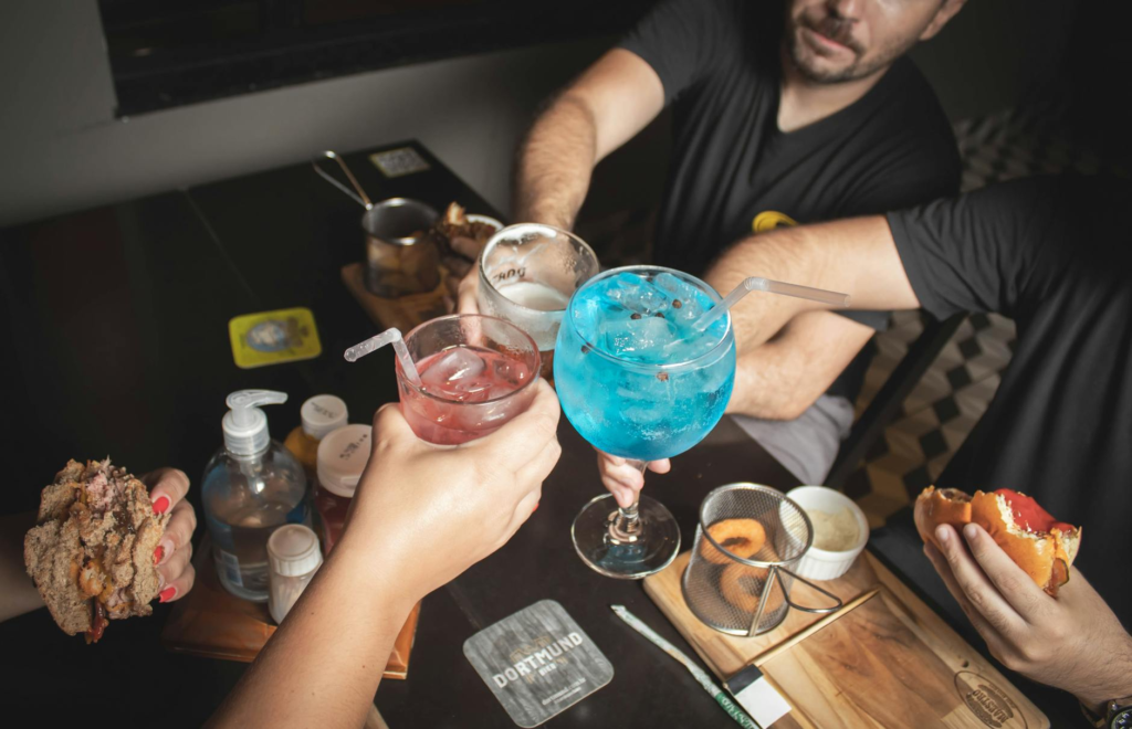 A group enjoying burgers and drinks at an outdoor Las Vegas event — Las Vegas burger deals events