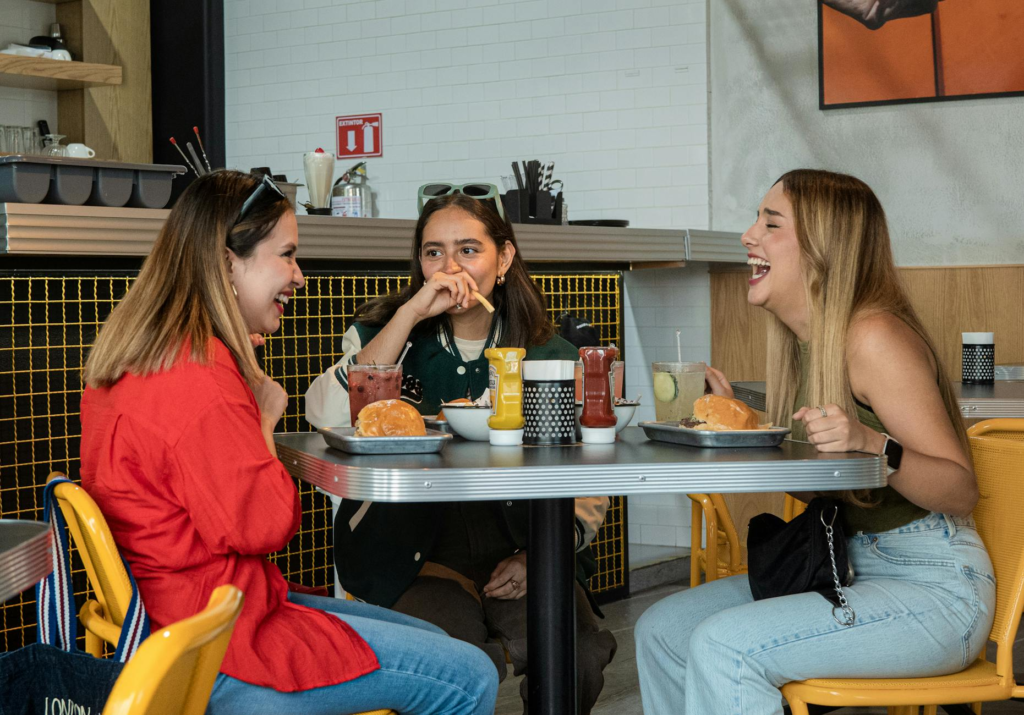 A group of friends enjoying a burger deal at a lively Las Vegas eatery. — burger deals Las Vegas
