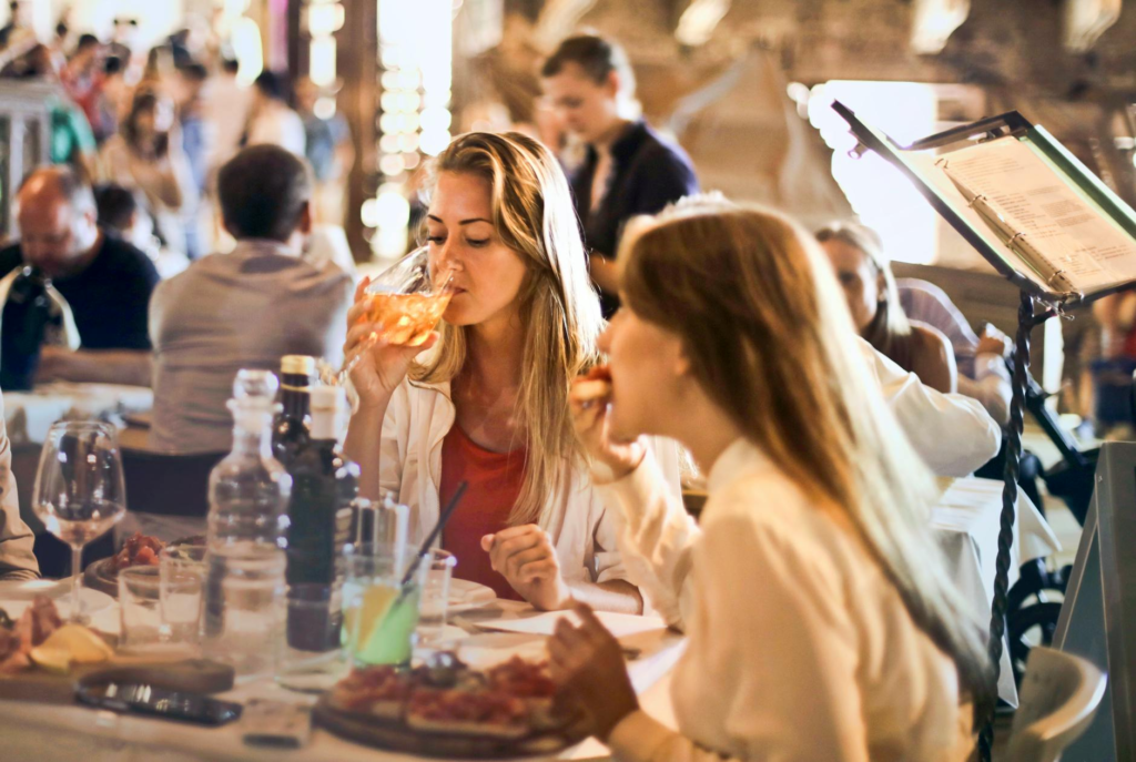 A group of friends enjoying a gourmet burger feast at a Las Vegas restaurant, showcasing the social aspect of dining. — …
