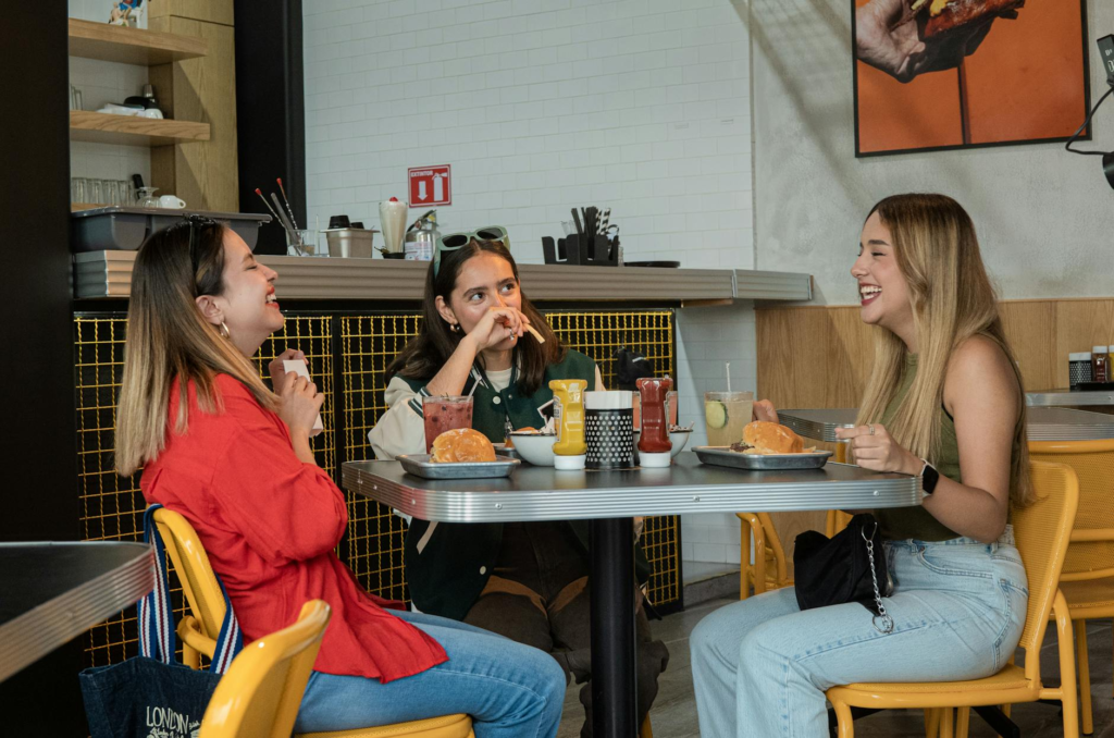 A group of friends enjoying burgers and fries at a bustling restaurant. — burger joints Las Vegas Strip