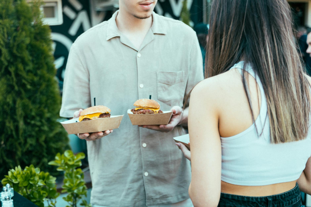 A group of friends enjoying burgers at an outdoor patio of a hidden gem. — hidden burger gems Las Vegas