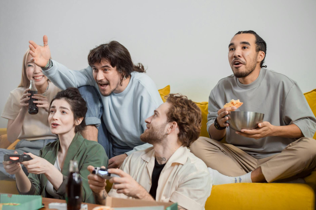 A group of friends enjoying cheeseburger sliders game day while watching a game