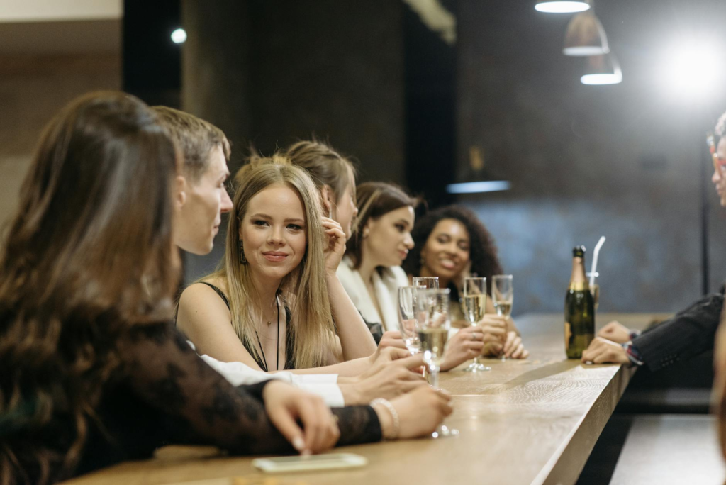 A group of friends enjoying happy hour burgers at a bustling bar in Las Vegas. — burger deals Las Vegas