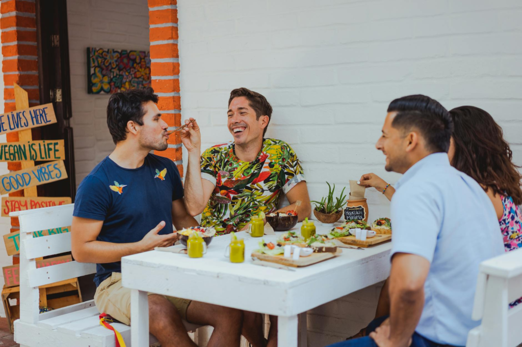 A happy group of friends enjoying a meal at a vegan-friendly restaurant in Las Vegas. — vegan burgers Las Vegas