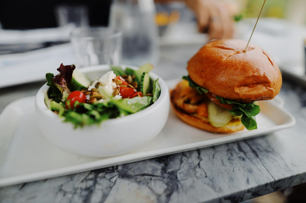 A healthy vegan meal featuring a colorful salad alongside a burger. — vegan burgers Las Vegas