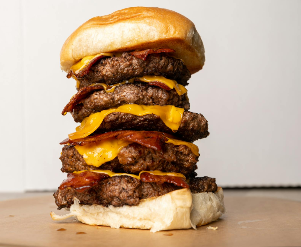 A mouth-watering burger stacked high with toppings from The Heart Attack Grill. — unique burgers Las Vegas