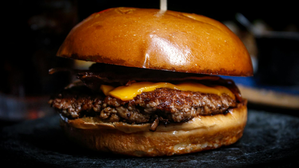 A mouth-watering close-up of a juicy burger from The Burger Bar. — burger specials Las Vegas