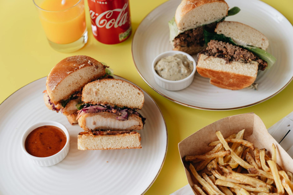 A plate of spicy burgers accompanied by unique dipping sauces and sides. — spicy burgers Las Vegas