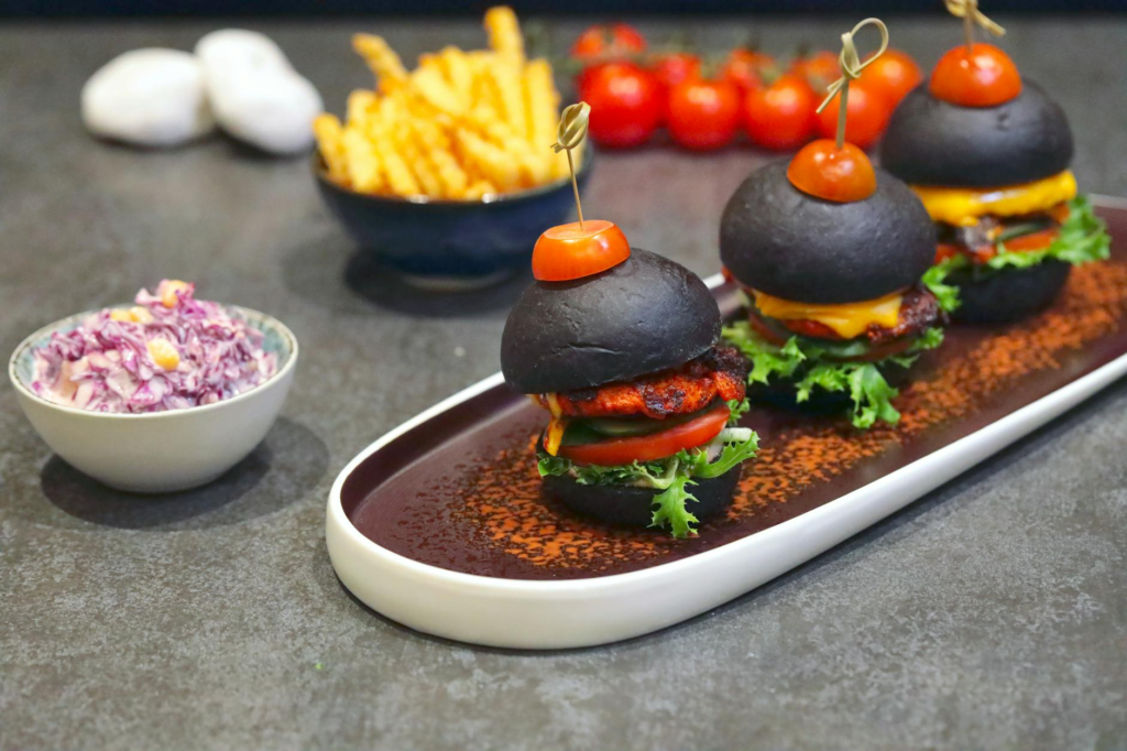 A platter of cheeseburger sliders with a variety of side dishes like fries and coleslaw. — side dishes for cheeseburger …