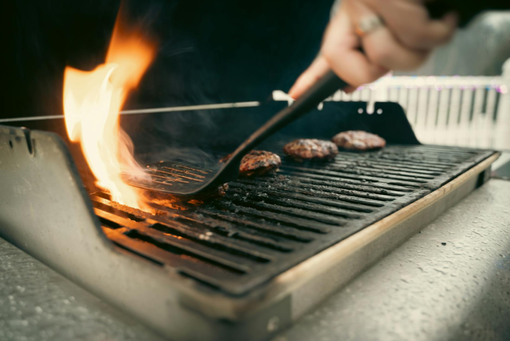 A sizzling burger on the grill, capturing the cooking process outdoors. — Las Vegas burger recipes
