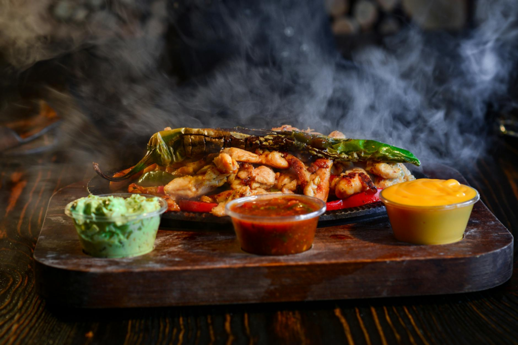 A sizzling image of The Spicy Jalapeño Smash with peppers and sauces — best burgers in Las Vegas