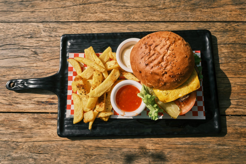 A stylish shot of a burger platter with fries and dipping sauces, showcasing classic cheeseburgers Las Vegas.