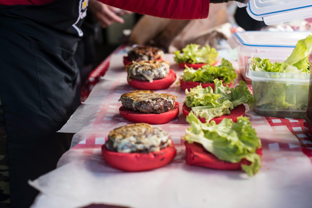 A table display showing a build-your-own burger station with toppings to help you host a holiday burger party in Las Vegas…