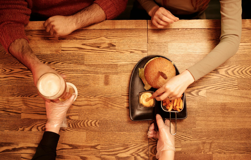 A table setting featuring cheeseburger sliders and several drink options for a casual gathering. — drinks to pair with c…
