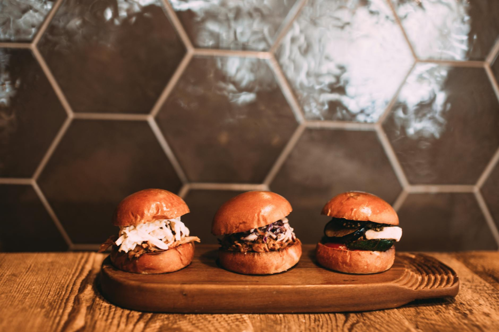 A table with a variety of cheeseburger sliders ready for a challenge — cheeseburger slider challenges Las Vegas