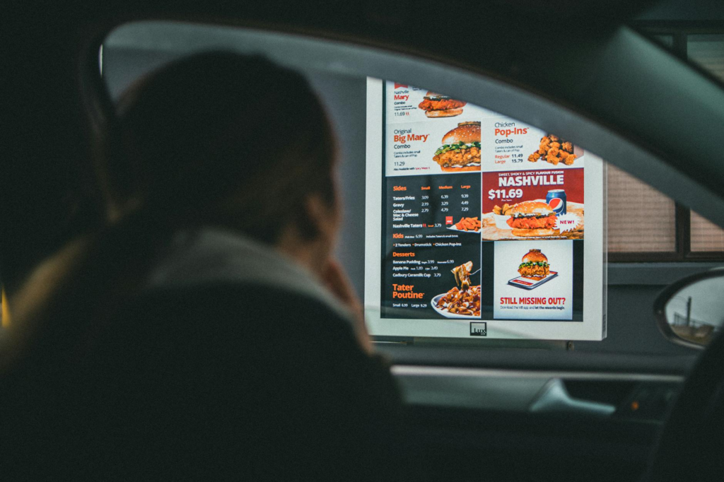 A tech-savvy restaurant with patrons ordering burgers through tablets, embodying the burger trends Las Vegas 2026.