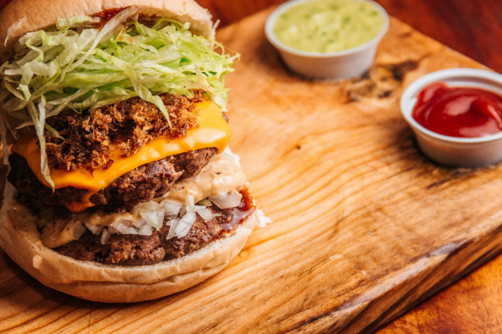 A vibrant burger with unique toppings, surrounded by colorful condiments and sides. — Instagrammable burgers Las Vegas