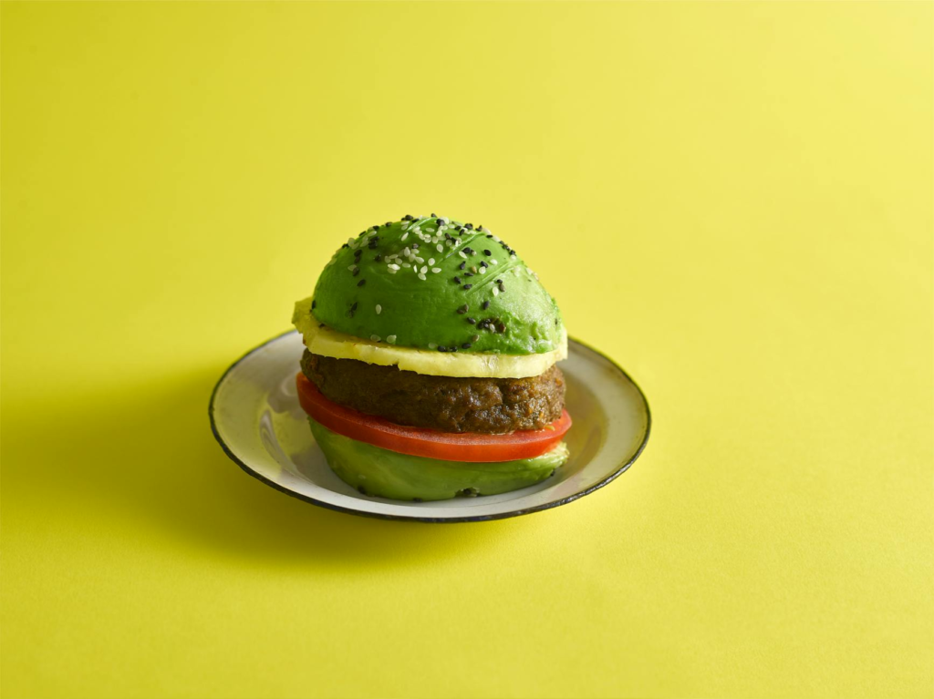 A vibrant healthy burger topped with fresh vegetables and avocado, showcasing nutritious ingredients. — healthy burgers …
