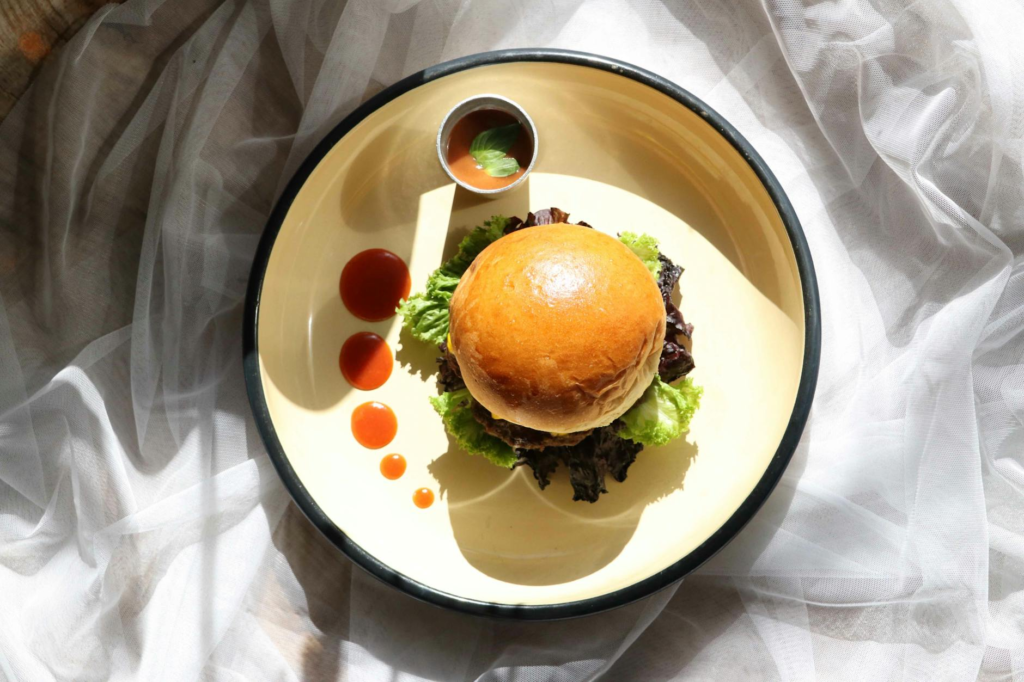 A vibrant plate of a vegan burger topped with fresh vegetables and sauces. — vegan burgers Las Vegas