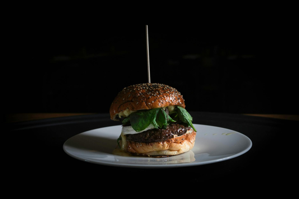 A vibrant plate showcasing the Juicy Spring Burger at The Burger Bar, a highlight among burger specials Las Vegas this spring.