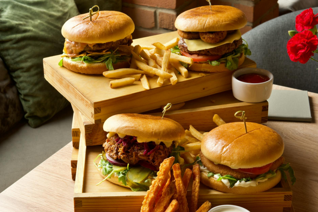 A wide variety of gourmet burgers displayed on a table in a family-friendly dining setting. — family-friendly burgers La…